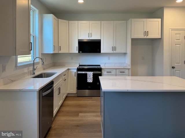 kitchen featuring stainless steel range with electric stovetop, a sink, dishwasher, recessed lighting, and white cabinets