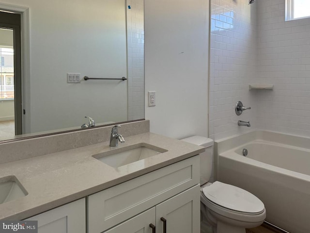 bathroom with toilet, double vanity, and shower / washtub combination