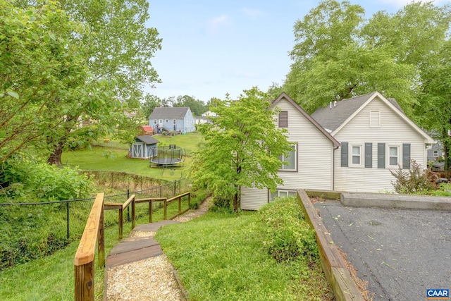 1216 Grove St, Charlottesville, VA 22903 - rear view of property with a trampoline and an outdoor structure