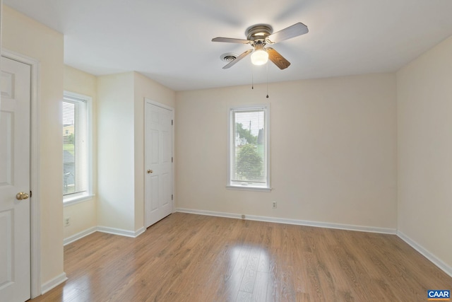 1216 Grove St, Charlottesville, VA 22903 - unfurnished bedroom with multiple windows, light wood-style flooring, baseboards, and a ceiling fan