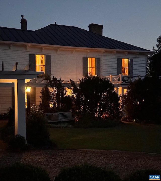10064 Hatton Ferry Ln, Scottsville, VA 24590 - view of side of home featuring a standing seam roof, a chimney, metal roof, and a yard