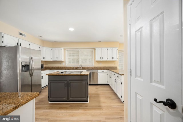 6904 Lakeland Way, Fredericksburg, VA 22407 - kitchen featuring stainless steel appliances, white cabinets, light wood-type flooring, dark stone counters, and recessed lighting