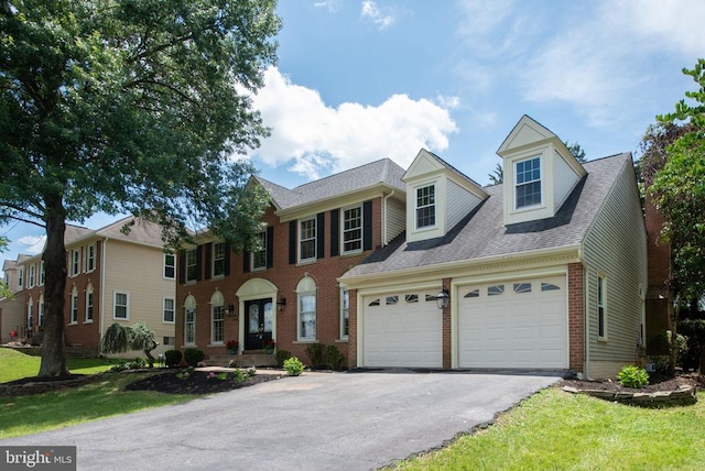 6904 Lakeland Way, Fredericksburg, VA 22407 - view of front facade featuring a garage, asphalt driveway, brick siding, roof with shingles, and a front lawn