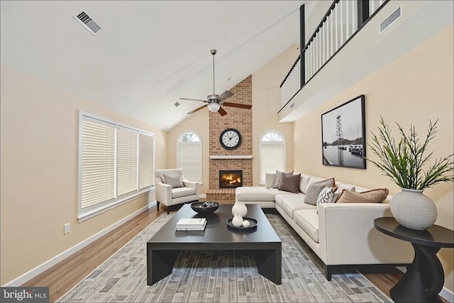 6904 Lakeland Way, Fredericksburg, VA 22407 - living area featuring wood finished floors, ceiling fan, a brick fireplace, and high vaulted ceiling