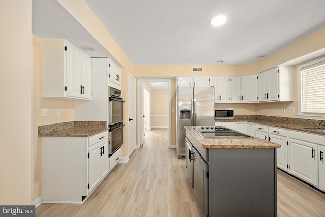6904 Lakeland Way, Fredericksburg, VA 22407 - kitchen featuring appliances with stainless steel finishes, white cabinets, a kitchen island, light wood finished floors, and recessed lighting