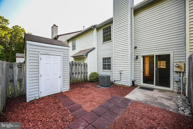 11175 Elwyn Ct, Fredericksburg, VA 22407 - rear view of house with central AC, a chimney, a fenced backyard, and a patio