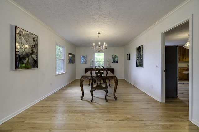 1217 Windsor Rd, Harrisonburg, VA 22801 - dining room with a notable chandelier, light wood-type flooring, a textured ceiling, baseboards, and ornamental molding