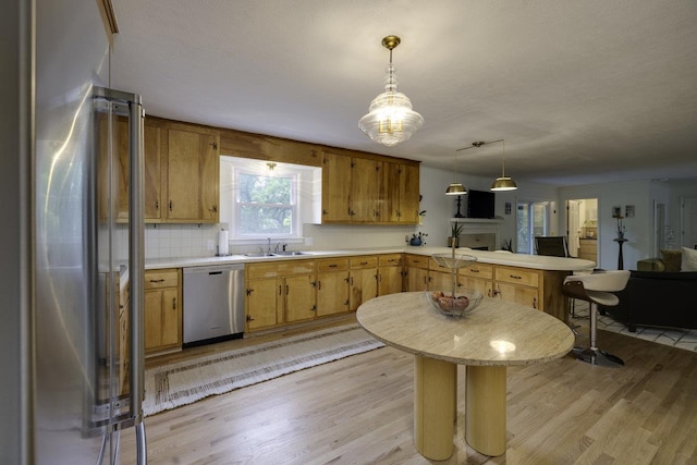1217 Windsor Rd, Harrisonburg, VA 22801 - kitchen featuring a peninsula, stainless steel appliances, light countertops, and light wood-style flooring