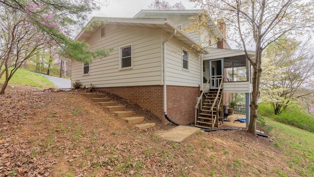 1217 Windsor Rd, Harrisonburg, VA 22801 - view of side of property featuring a sunroom, stairway, and a chimney