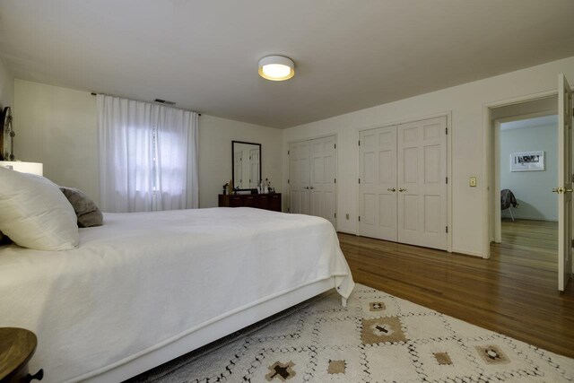 1217 Windsor Rd, Harrisonburg, VA 22801 - bedroom with baseboards, multiple closets, visible vents, and wood finished floors