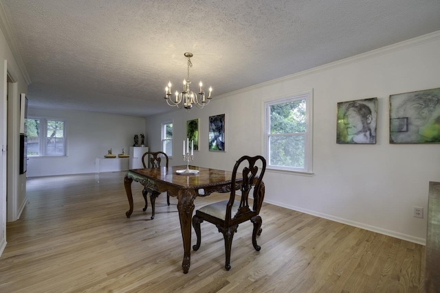 1217 Windsor Rd, Harrisonburg, VA 22801 - dining room with light wood finished floors, a textured ceiling, a notable chandelier, and a healthy amount of sunlight