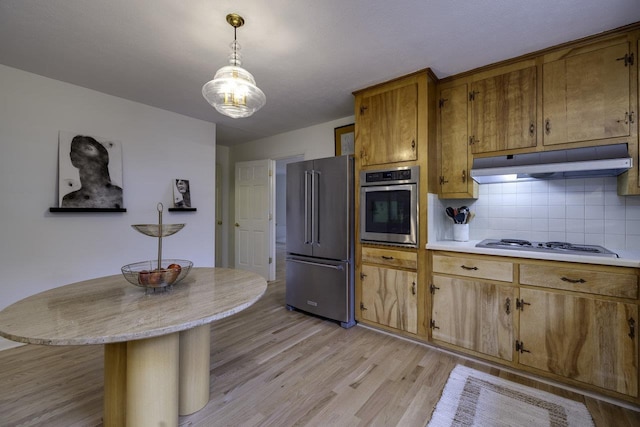 1217 Windsor Rd, Harrisonburg, VA 22801 - kitchen with light wood-style flooring, under cabinet range hood, brown cabinetry, light countertops, and appliances with stainless steel finishes
