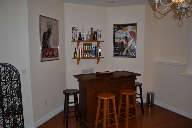 2894 Cullison Ct, Rockingham, VA 22801 - indoor dry bar with dark wood-type flooring, a chandelier, and baseboards