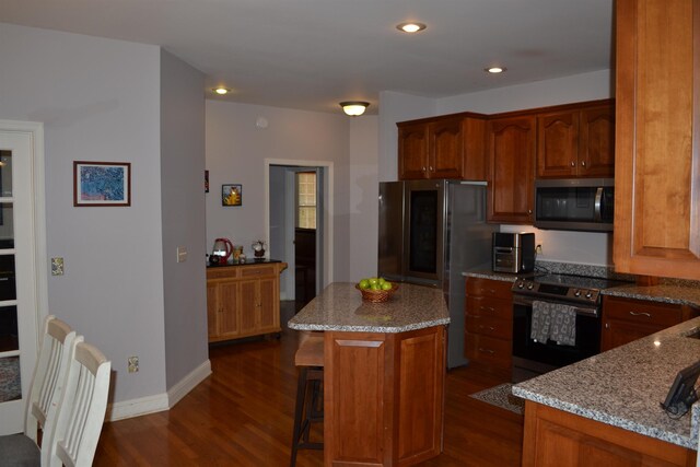 2894 Cullison Ct, Rockingham, VA 22801 - kitchen featuring stainless steel appliances, dark wood-type flooring, light stone countertops, a kitchen island, and a breakfast bar