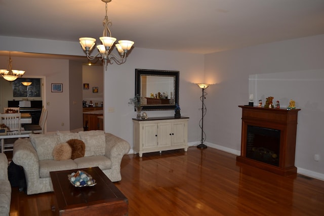 2894 Cullison Ct, Rockingham, VA 22801 - living room featuring a chandelier, a fireplace, dark wood finished floors, and baseboards