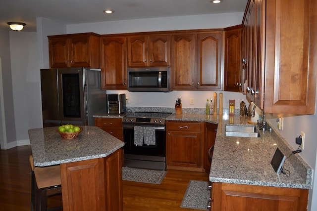 2894 Cullison Ct, Rockingham, VA 22801 - kitchen with appliances with stainless steel finishes, a sink, wood finished floors, light stone countertops, and recessed lighting