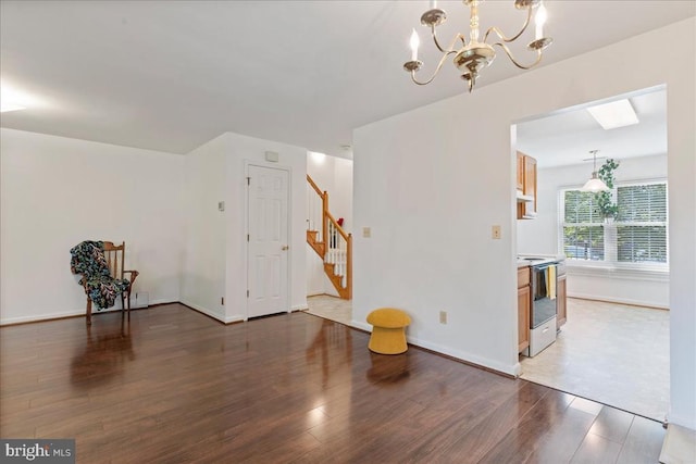 648 Ripplebrook Dr, Culpeper, VA 22701 - unfurnished living room with wood finished floors, a chandelier, stairs, and baseboards