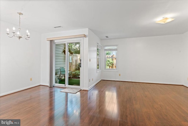 648 Ripplebrook Dr, Culpeper, VA 22701 - empty room featuring a chandelier, wood finished floors, and baseboards