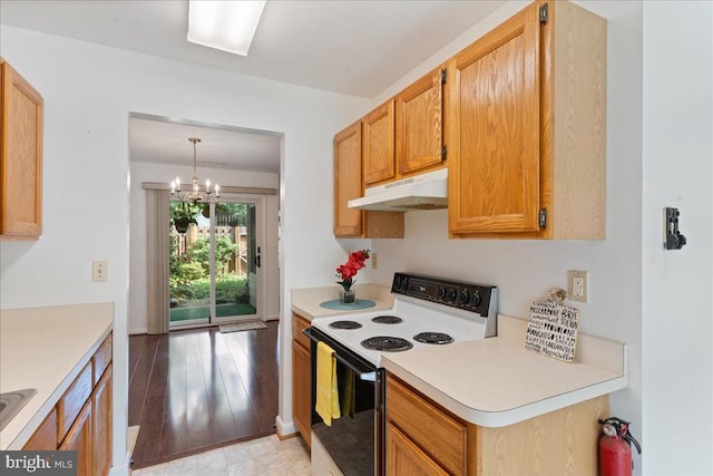 648 Ripplebrook Dr, Culpeper, VA 22701 - kitchen featuring range with electric stovetop, under cabinet range hood, light countertops, a chandelier, and light wood-style flooring