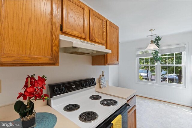 648 Ripplebrook Dr, Culpeper, VA 22701 - kitchen with white range with electric stovetop, under cabinet range hood, light countertops, brown cabinetry, and hanging light fixtures