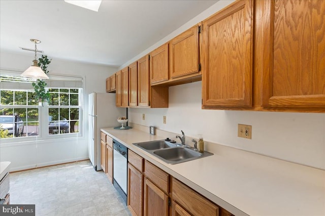 648 Ripplebrook Dr, Culpeper, VA 22701 - kitchen with a sink, light countertops, white dishwasher, decorative light fixtures, and brown cabinetry