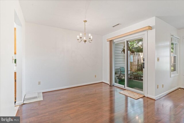 648 Ripplebrook Dr, Culpeper, VA 22701 - unfurnished room featuring healthy amount of natural light, a chandelier, wood finished floors, and baseboards