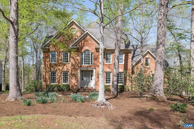 colonial-style house with brick siding