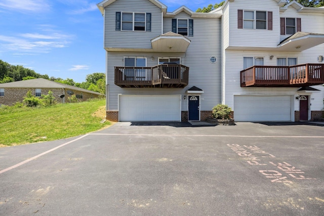 872 Camelot Ln, Harrisonburg, VA 22801 - view of front of property with a balcony, brick siding, driveway, a front yard, and a garage