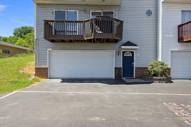 872 Camelot Ln, Harrisonburg, VA 22801 - view of property featuring a balcony, brick siding, an attached garage, and driveway