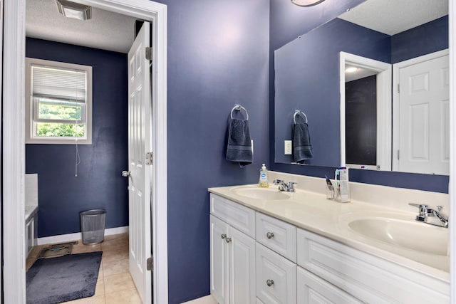 872 Camelot Ln, Harrisonburg, VA 22801 - full bathroom featuring double vanity, tile patterned floors, a textured ceiling, and baseboards