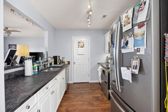 872 Camelot Ln, Harrisonburg, VA 22801 - kitchen featuring appliances with stainless steel finishes, a sink, dark countertops, dark wood-style floors, and white cabinetry