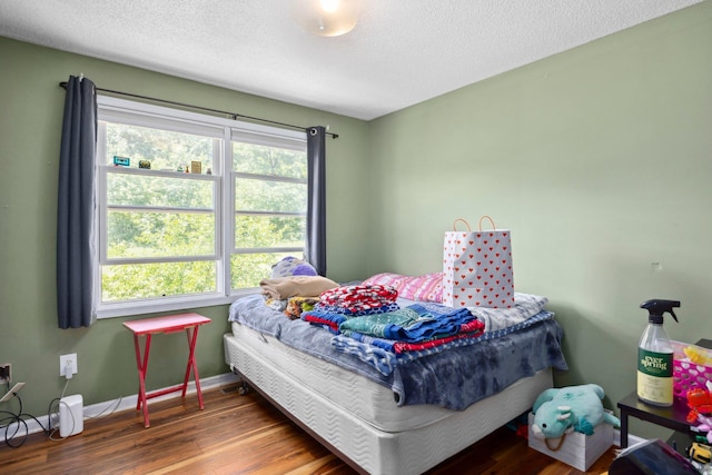 872 Camelot Ln, Harrisonburg, VA 22801 - bedroom featuring multiple windows, wood finished floors, baseboards, and a textured ceiling