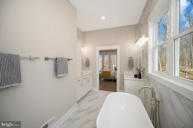 60 Laurelwood Dr, Mineral, VA 23117 - ensuite bathroom featuring a freestanding bath, marble look tile flooring, vanity, and recessed lighting