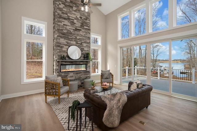 60 Laurelwood Dr, Mineral, VA 23117 - living area with high vaulted ceiling, a fireplace, wood finished floors, a water view, and ceiling fan