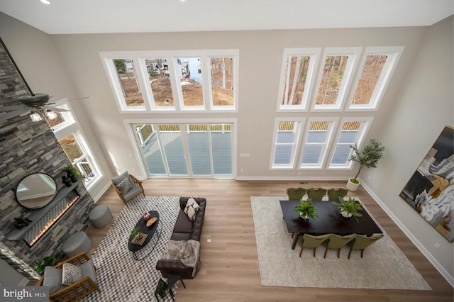 60 Laurelwood Dr, Mineral, VA 23117 - living area featuring a warm lit fireplace, wood finished floors, and a high ceiling