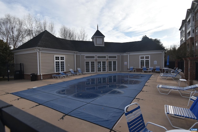 community pool featuring a patio and french doors