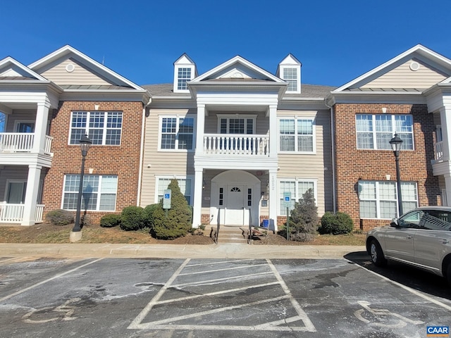 view of building exterior featuring uncovered parking