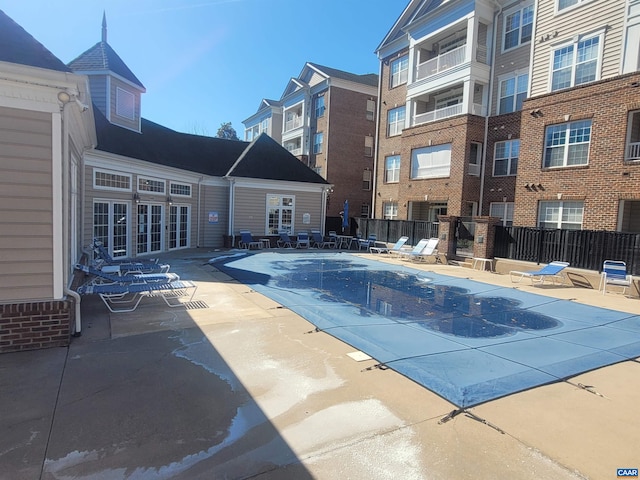 community pool featuring a patio area and fence
