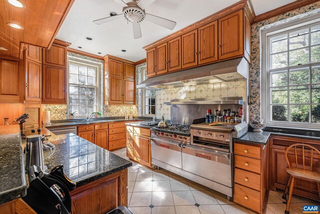 19184 Mt Sharon Rd, Orange, VA 22960 - kitchen featuring under cabinet range hood, light tile patterned flooring, tasteful backsplash, and brown cabinets