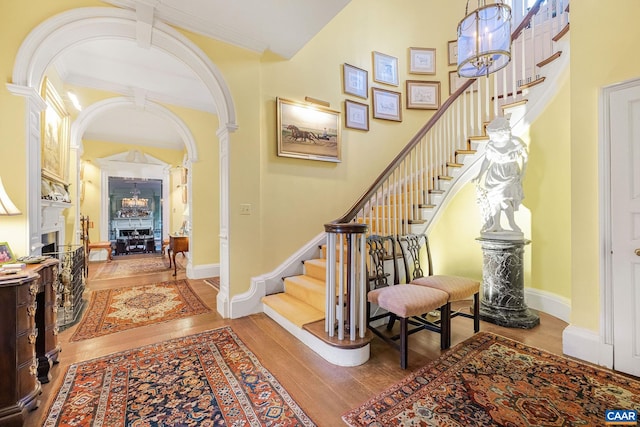 19184 Mt Sharon Rd, Orange, VA 22960 - entrance foyer featuring stairs, hardwood / wood-style floors, a fireplace, crown molding, and arched walkways