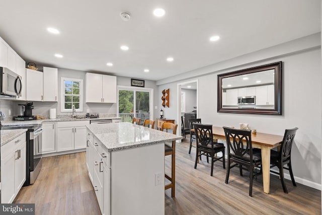 8558 Opal Rd, Warrenton, VA 20186 - kitchen featuring appliances with stainless steel finishes, a kitchen breakfast bar, a center island, white cabinets, and recessed lighting
