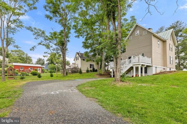8558 Opal Rd, Warrenton, VA 20186 - view of home's exterior with a deck, stairway, a chimney, a metal roof, and a lawn
