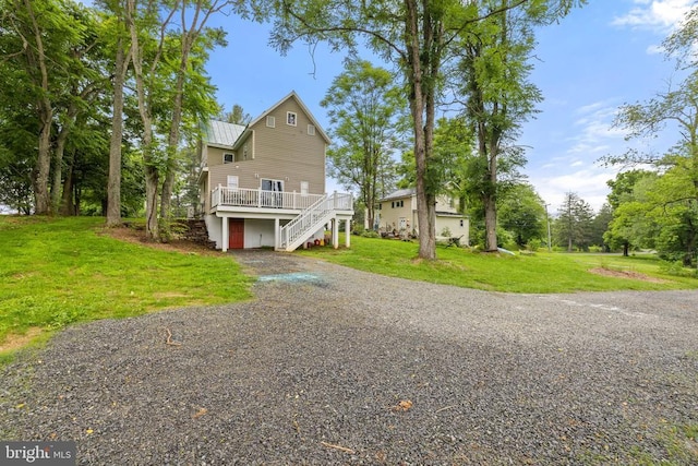 8558 Opal Rd, Warrenton, VA 20186 - view of front of home with stairs, driveway, a wooden deck, a metal roof, and a front yard