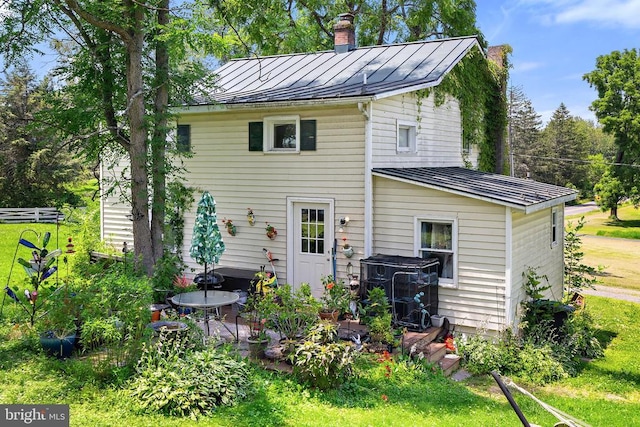 8558 Opal Rd, Warrenton, VA 20186 - back of property with a standing seam roof, a metal roof, a chimney, and a yard