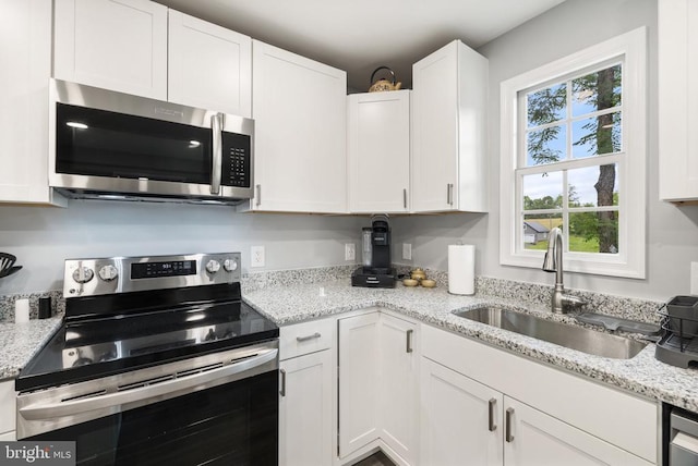 8558 Opal Rd, Warrenton, VA 20186 - kitchen featuring appliances with stainless steel finishes, white cabinets, and light stone counters