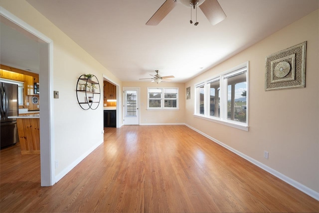 10999 Orkney Grade, Mount Jackson, VA 22842 - unfurnished living room featuring a ceiling fan, baseboards, light wood-style floors, and a glass covered fireplace