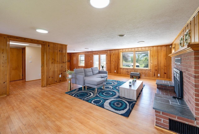 10999 Orkney Grade, Mount Jackson, VA 22842 - living area featuring a fireplace, wood finished floors, wooden walls, and a textured ceiling
