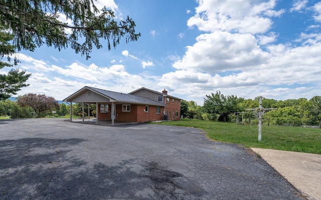 10999 Orkney Grade, Mount Jackson, VA 22842 - view of home's exterior with a yard, driveway, a chimney, an attached carport, and metal roof