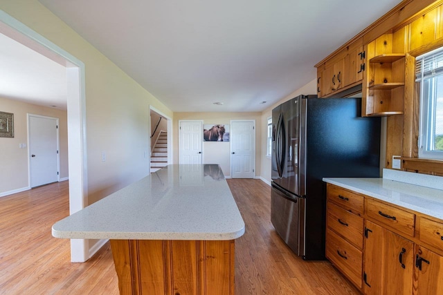 10999 Orkney Grade, Mount Jackson, VA 22842 - kitchen featuring freestanding refrigerator, open shelves, brown cabinets, light wood-style flooring, and a kitchen island