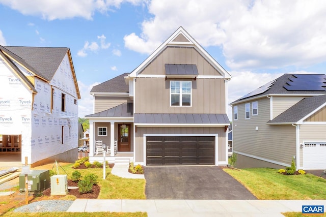 300 Fowler St, Charlottesville, VA 22901 - view of front facade featuring a standing seam roof, board and batten siding, metal roof, driveway, and an attached garage